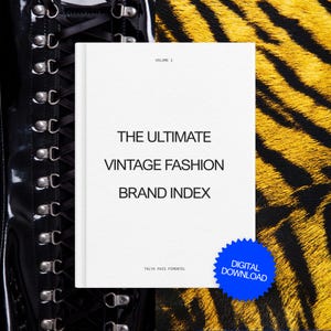May include: A white book cover titled The Ultimate Vintage Fashion Brand Index Volume 1 by Talya Pais Pimentel, featuring a blue starburst sticker labeled Digital Download, positioned between a black lace-up boot and a yellow and black tiger print.