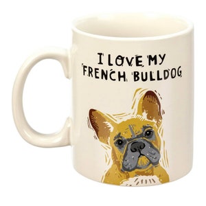 May include: White ceramic mug with a brown and black illustration of a French Bulldog. The mug has black text that reads "I love my French Bulldog".