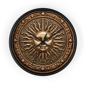 May include: A round wall clock with a bronze-colored sun design at the center. The sun has a face and is surrounded by rays. The clock face is framed by a decorative border and a black outer rim. The clock hands are black.