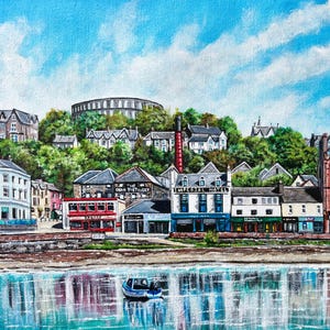 May include: A painting of a waterfront town with colorful buildings, a blue sky with white clouds, and a small boat in the water. The buildings have signs that read "The Oban Distillery" and "Imperial Hotel".