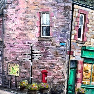 May include: A detailed acrylic painting depicting a traditional street scene. The image shows stone buildings, a red postbox, and a black signpost. Flower-filled planters sit at the base of the buildings, adding a splash of colour to the scene.