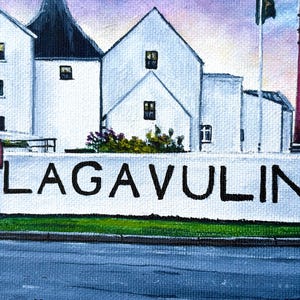 May include: An oil painting depicts a distillery with white buildings, a red smokestack, and a wall with the word "LAGAVULIN" in black letters. A red mailbox is visible on the left side of the image. The sky is a mix of purple and blue.