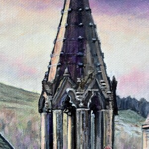May include: An oil painting of a church spire, rendered in dark hues, dominates the frame. The spire's intricate details are highlighted against a backdrop of a pastel sky. The artwork captures a serene landscape with hints of buildings and a hillside, showcasing a blend of colours.