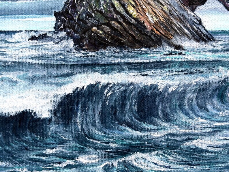 May include: An oil painting depicts a dramatic seascape. Dark blue waves crash against a rocky cliff face, creating white foam. The sky is a pale blue, and the overall mood is one of power and the sea.