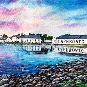 May include: A painting of a white building with the words "Laphroaig" on the side, reflected in a body of water. The water is a light blue color and there are rocks in the foreground. The sky is a light blue color with pink clouds.