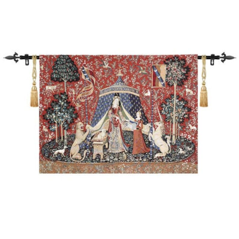 May include: A tapestry depicting a scene from the Unicorn Tapestries. A woman in a blue and gold gown stands under a canopy, holding a unicorn. A lion and a dog are also present in the scene. The tapestry is woven with intricate details and vibrant colors.