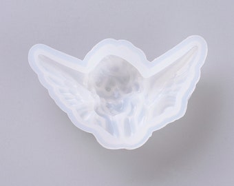 May include: A white silicone mold shaped like an angel with wings. The mold is designed to create a resin or polymer clay angel figurine.