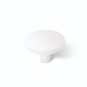 May include: White ceramic knob with a round top and a cylindrical base.