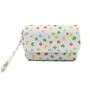 May include: White clutch bag with a flap closure and wrist strap. The bag features a colourful pattern of icons, including fruit, bugs, and tools. The wrist strap has a matching pattern. The bag is a compact size.