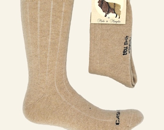 May include: A pair of tan ribbed cashmere socks with a tag that reads "Cashmere 100% Made in Mongolia".