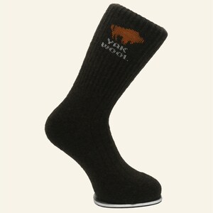May include: Dark brown wool socks with a brown bear logo and the text "Wilderness Recreation" in white.