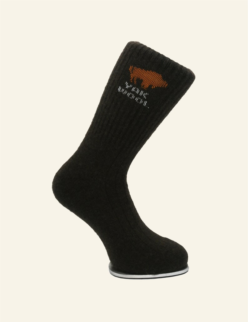 May include: Dark brown wool socks with a brown bear logo and the text "Wilderness Recreation" in white.