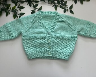 Baby’s mint hand knitted cardigan, personalise with name embroidered onto the back. Roughly fit 3/6 months