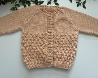 Toddler caramel peach hand knitted cardigan, personalise with name embroidered onto the back. Roughly fit 1-2 years