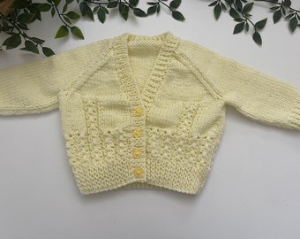 Baby’s pale yellow hand knitted cardigan, personalise with name embroidered on the back. Roughly fit 6 months