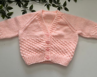 Baby’s peach hand knitted cardigan, personalise with name embroidered onto the back. Roughly fit 6 months