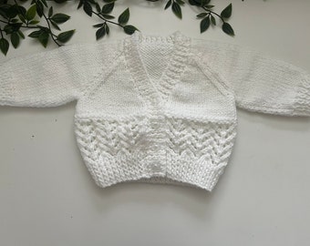 Baby’s white hand knitted cardigan, personalise with name embroidered onto the back. Roughly fit 0/3 months