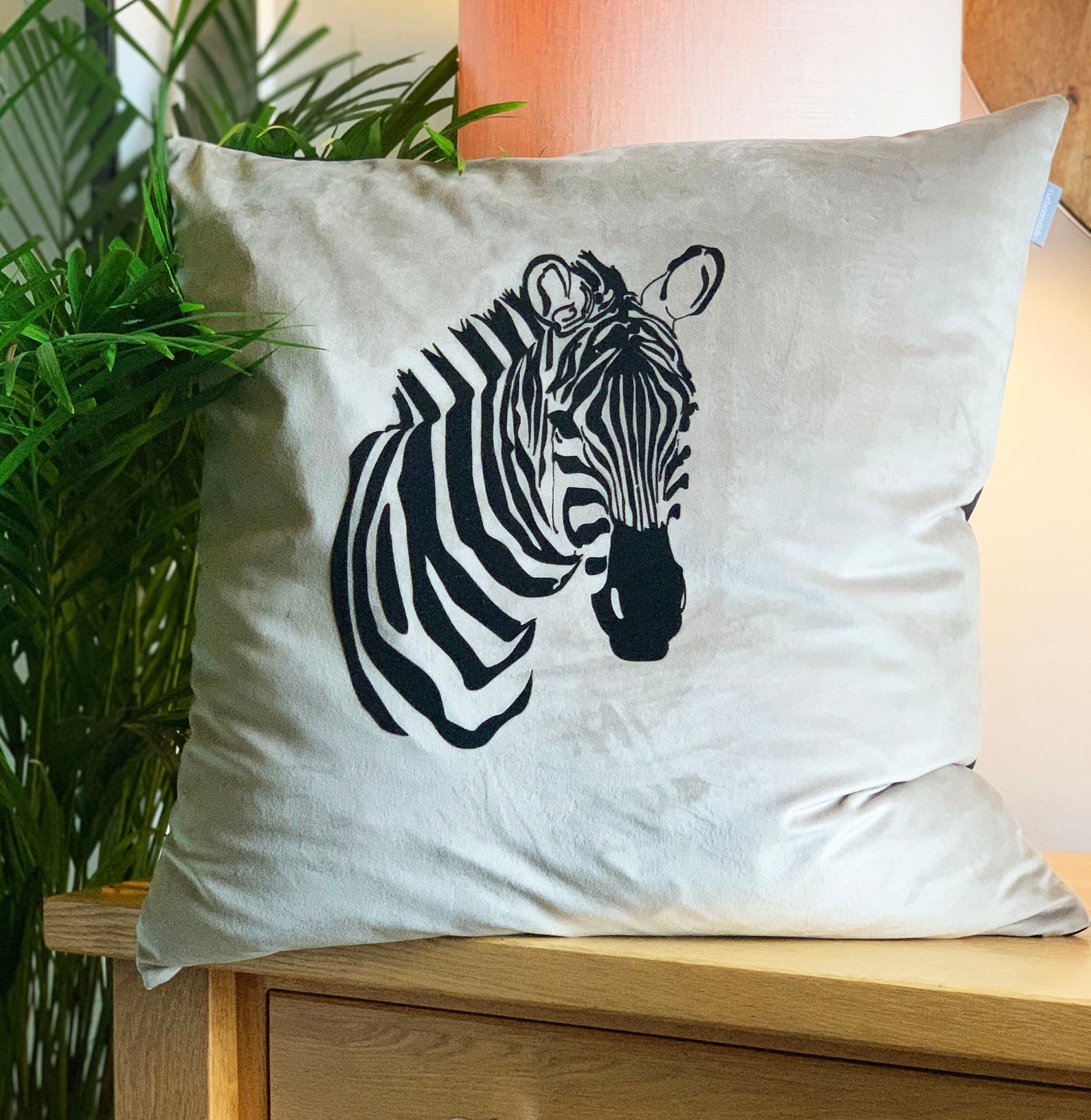 Luxury velvet zebra cushion with feather infill shown in Etsy