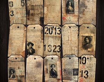 May include: A collection of 12 vintage-style paper tags with various designs. Some tags feature numbers, others have text, and some have images of people. The tags are all in shades of brown, cream, and white, with a distressed look.