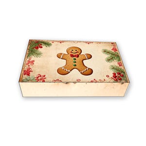 May include: A vintage-style gift box with a gingerbread man design. The box is decorated with red berries, green pine branches, and a white background.