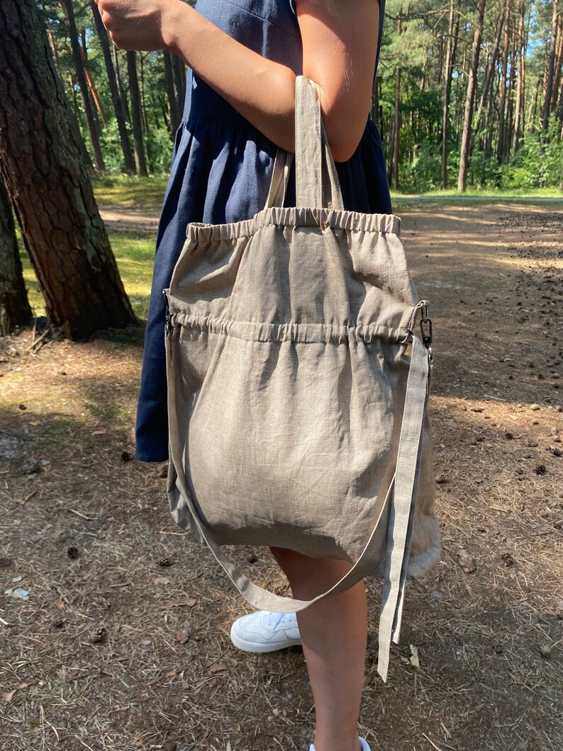 Linen tote bag. Handmade from waxed linen. The bag is rectangular shape with short handles and shoulder strap, has inside pocket for phone and wallet. The tote bag closes with side straps.