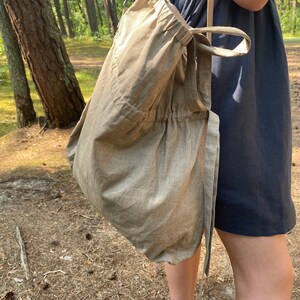 Linen tote bag. Handmade from waxed linen. The bag is rectangular shape with short handles and shoulder strap, has inside pocket for phone and wallet. The tote bag closes with side straps.