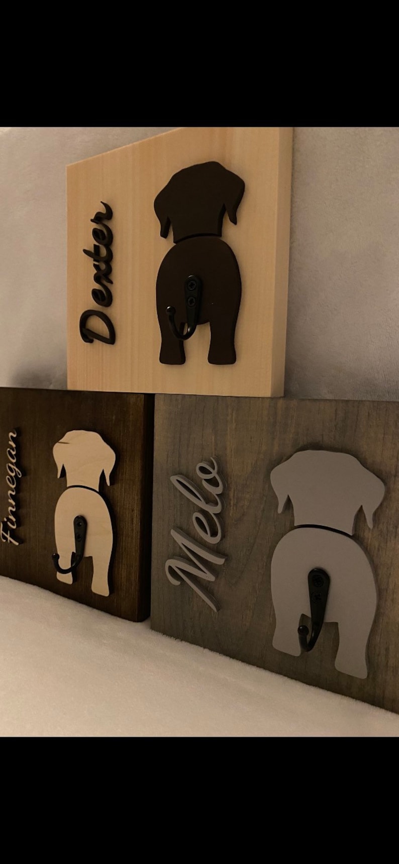 May include: Three wooden dog-shaped hooks with names "Dexter", "Finnegan", and "Melo" written on them. Each hook has a black metal hook.