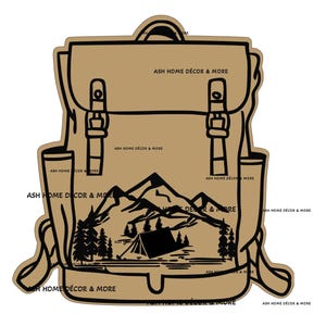 May include: A tan-colored backpack-shaped sticker with a black outline. The backpack design includes buckles, straps, and a mountain and tent scene. The text "ASH HOME DÉCOR & MORE" is repeated around the edges.