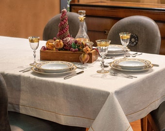 Christmas linen tablecloth with flashes of gold lurex yarns and gold embroidery. Square tablecloth.