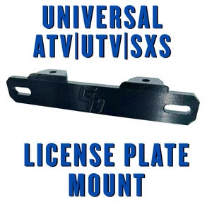 May include: A black license plate mount for ATVs, UTVs, and SXSs. The mount is rectangular with two mounting holes and two slots. The text "UNIVERSAL ATV|UTV|SXS" and "LICENSE PLATE MOUNT" are in blue.