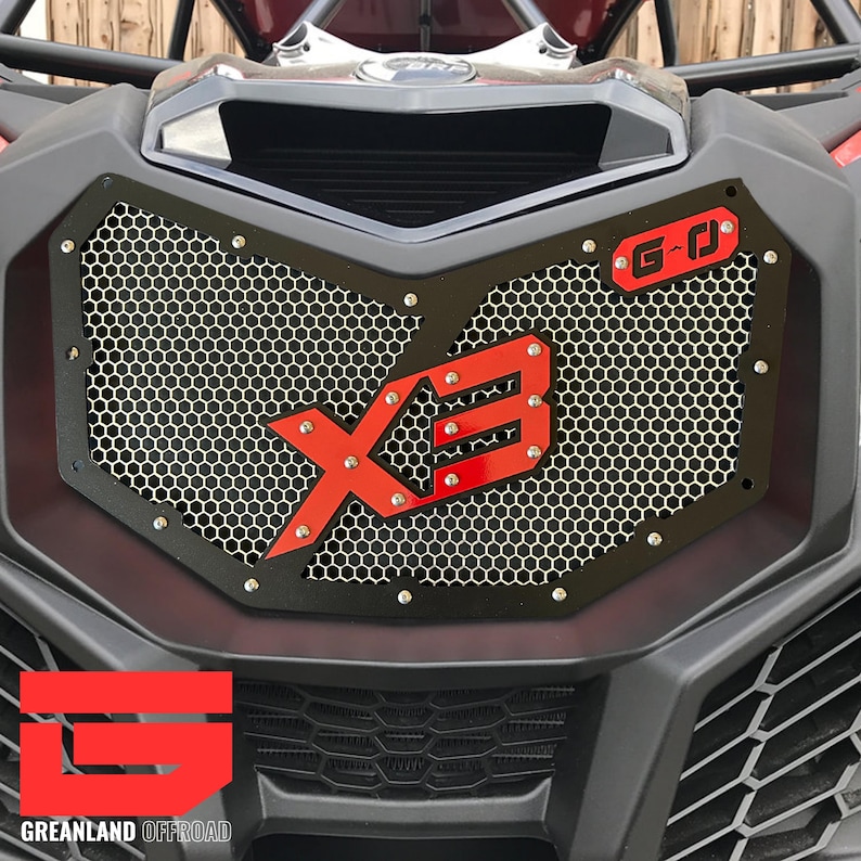 May include: Black metal grille with a red "X3" logo and a red "G-O" badge. The grille is designed to fit a vehicle with a honeycomb pattern.