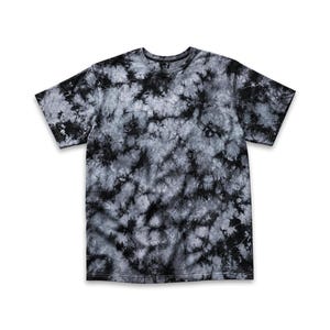 May include: A short-sleeve crew neck t-shirt featuring a black and gray tie-dye pattern. The design consists of dark black splotches and streaks blended with lighter gray and white tones across the entire fabric, creating a marbled effect.