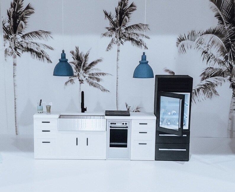 May include: A white kitchen with a stainless steel sink, a black oven, and a black refrigerator. The kitchen has a modern design and features two blue pendant lights.