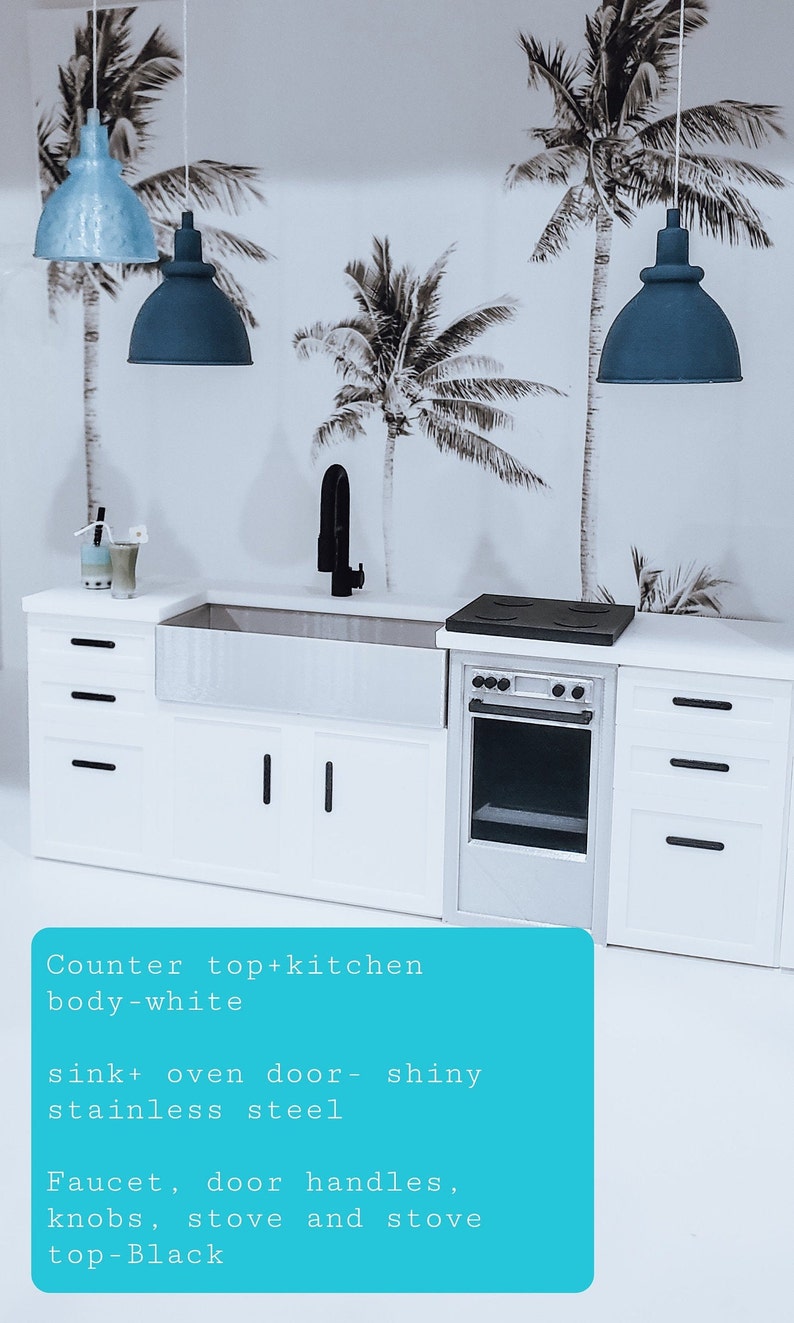 May include: A white kitchen cabinet with a farmhouse sink, black tap, and a stainless steel oven. The countertop is white and the cabinet doors have black handles. The backsplash features a tropical palm tree wallpaper.