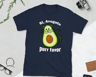 May include: Navy blue t-shirt with a white avocado design. The avocado has a cat face and the text "Si, Avogato purr favor".