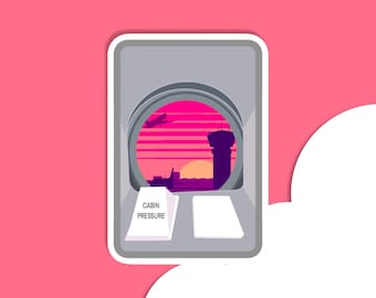 May include: A sticker of an airplane window with a view of a sunset over an airport runway. The sticker has a white border and the text "CABIN PRESSURE" on a white triangle.