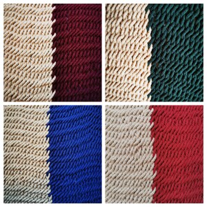 May include: Four close-up images of different colored bath mats. Each mat is made of a soft, textured fabric and has a beige stripe down the middle. The colors of the mats are burgundy, green, blue, and red.