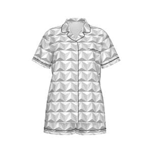 May include: White pajamas with a geometric pattern and black trim. The pajamas have short sleeves and a button-up front.
