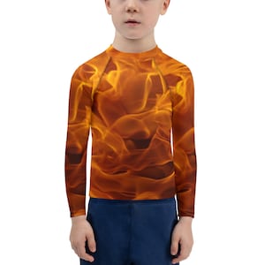 May include: A long-sleeved rash guard for kids with a bright orange and yellow flame pattern.