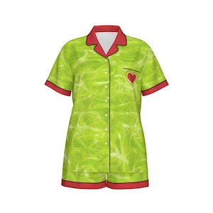 May include: Green and red short-sleeved pajama set with a heart design on the pocket. The pajamas have a button-up front and a collar.
