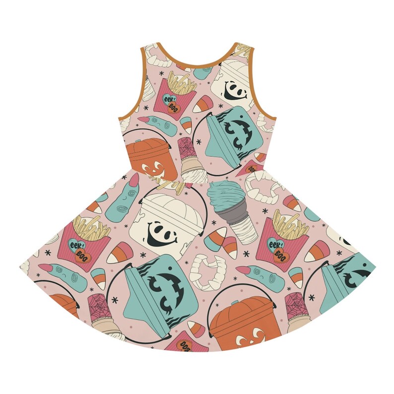 May include: A sleeveless dress with a pink background and a repeating Halloween-themed pattern. The pattern includes jack-o'-lantern buckets, mummy buckets, ice cream cones, french fries, candy corn, and a severed finger. The dress has a brown trim.