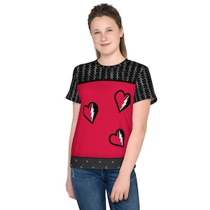 May include: A red t-shirt with three black hearts, each with a white lightning bolt. The top of the shirt and sleeves have a black and white chainmail pattern. The bottom of the shirt has a black studded design.