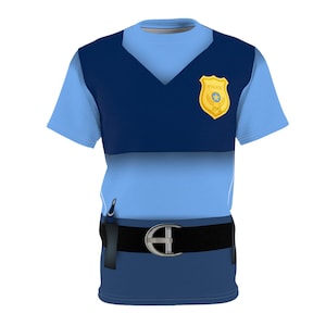 May include: A blue and navy blue t-shirt with a police badge on the chest. The shirt has a black belt with a silver buckle. The shirt is a costume for a police officer.