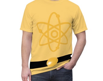 May include: A yellow t-shirt with a large yellow atom symbol on the front. The shirt has a black belt with a gold buckle.