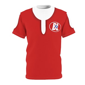 May include: A red short-sleeved t-shirt with a white collar and a white patch on the front. The patch has a blue circle with the letters 