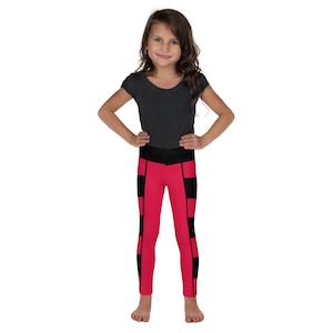 May include: A young person wearing black and pink leggings with a black waistband. The leggings have a geometric pattern of black and pink squares.