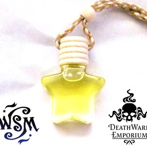 May include: A yellow star-shaped glass bottle with a white wooden cap and a gold string hanging from it. The bottle is filled with a clear liquid. The bottle is labelled "DeathWard Emporium".