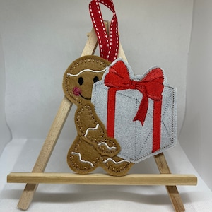 Gingerbread man carrying Christmas present, gingerbread decoration, Christmas decoration, Gingerbread men, Christmas gift, Gift for friends