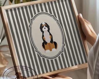 May include: A framed print featuring a Bernese Mountain Dog illustration. The dog is depicted in black, white, and brown, set against a cream-colored oval. The background has vertical gray and white stripes. The frame is made of light-colored wood. The print includes the text "Choohoo Kentucky EST 2016".