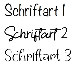 May include: Three different handwritten font styles of the word "Schriftart" in black ink on a white background. The word "Schriftart" is German for "font".